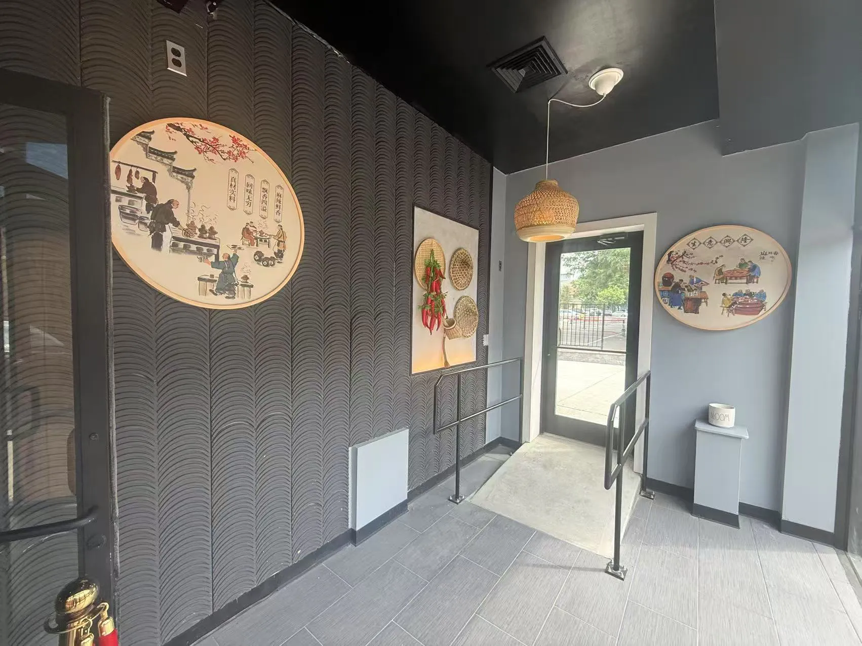 Restaurant entry hallway with traditional Chinese wall art and woven lamp at Chengdu Impression Chinese Restaurant in Schenectady