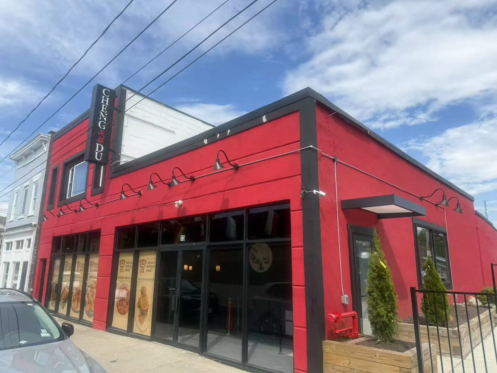 Exterior shot of bright red Chengdu restaurant storefront with signage at Chengdu Impression Chinese Restaurant in Schenectady